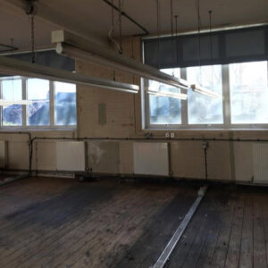 • The sewing room floor showing decades of wear from the workers shoes. Photo by Veronica Main.